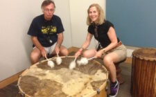Donna Dailey and Mike Gerrard of Arizona-Travel-Guide.com banging a huge drum at the Musical Instruments Museum in Scottsdale Arizona